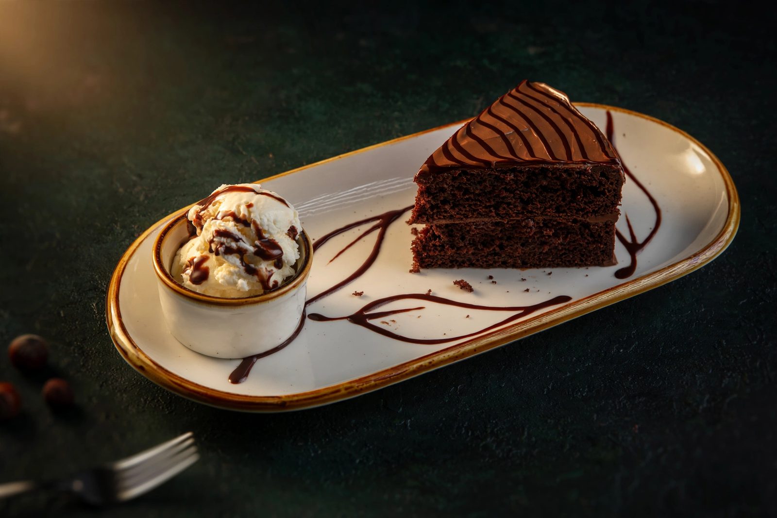 Nutella chocolate cake slice with vanilla ice cream