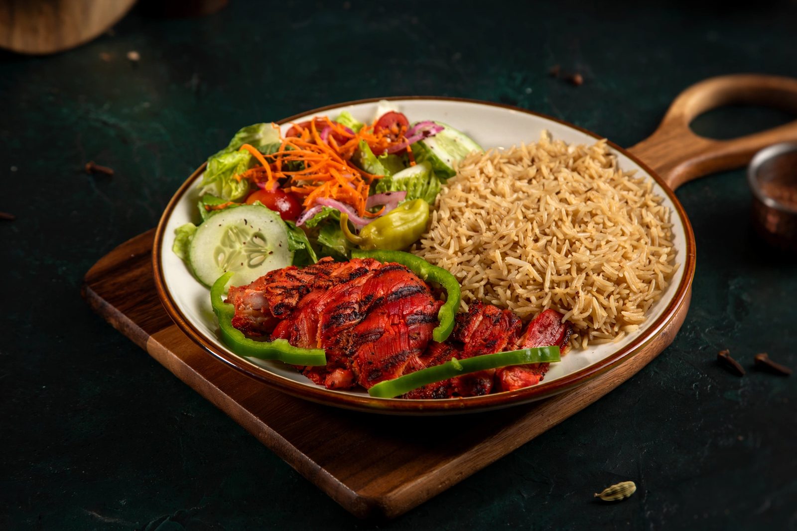 Char-grilled chicken tikka with basmati rice and salad